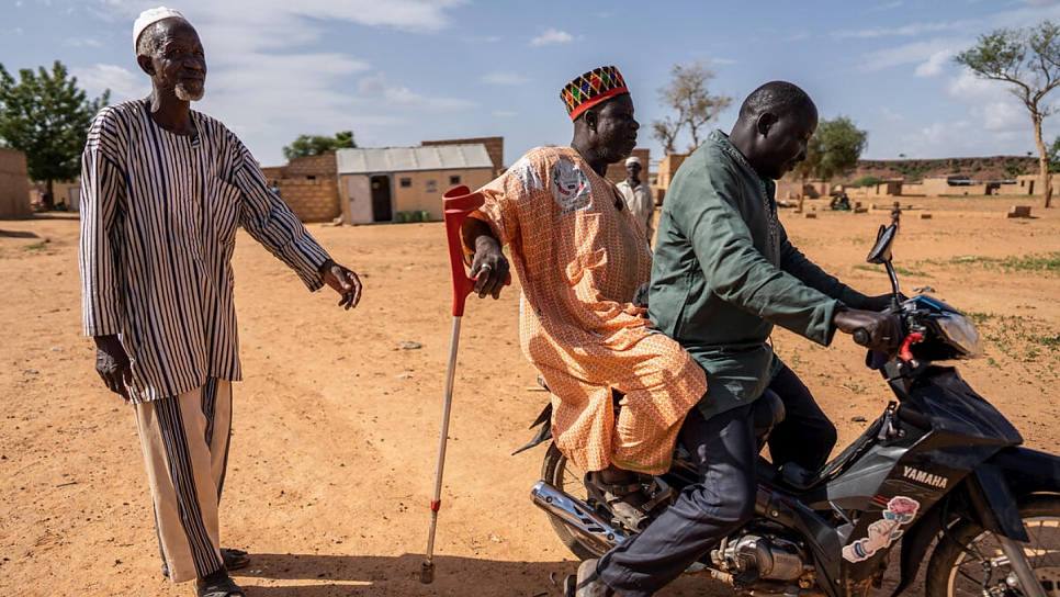 Following a motorcycle injury 12 years ago, Diambendi walks with a stick and often hitches a scooter ride to get around.