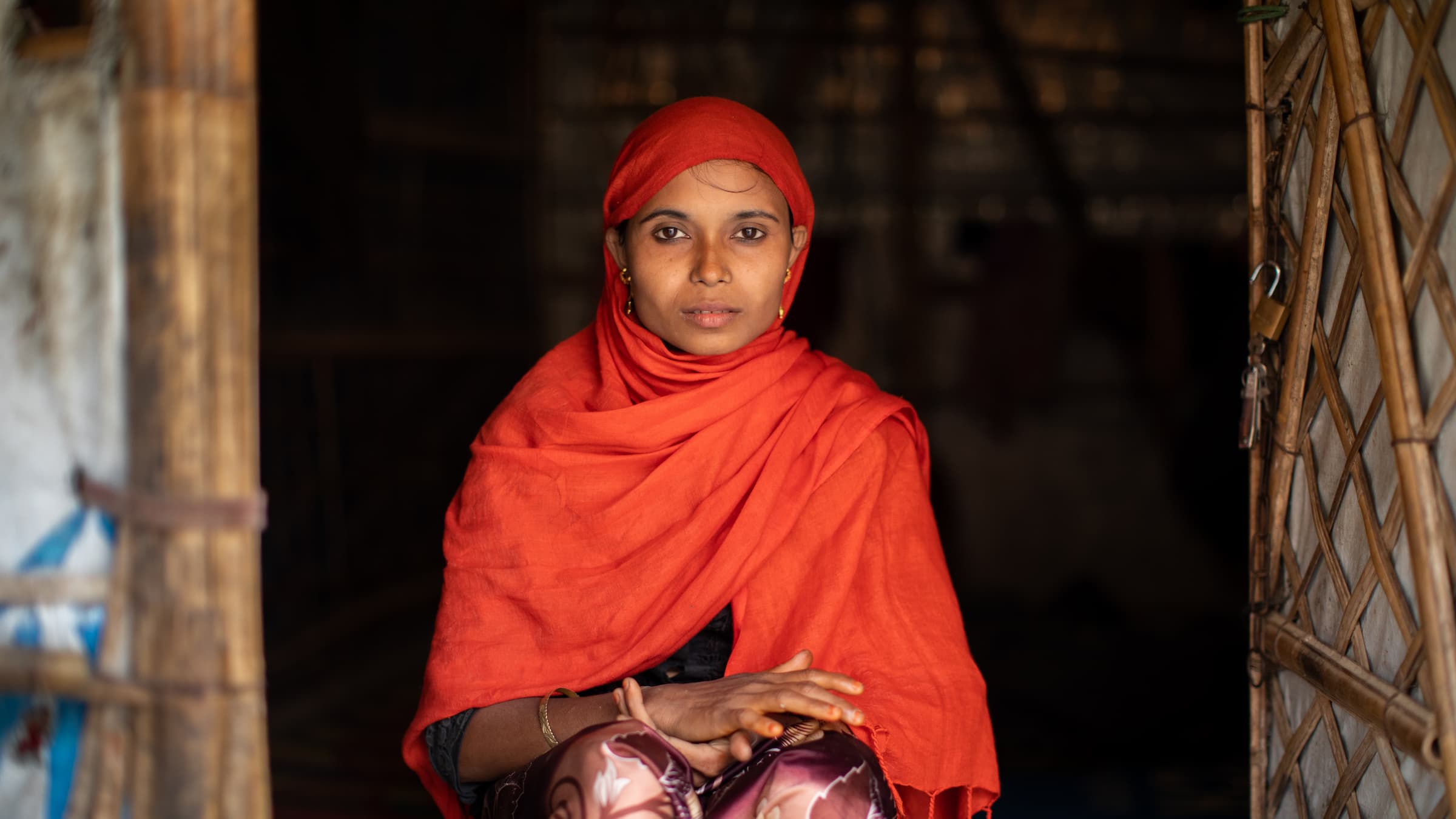 Bangladesh. Rofiqua Begum, a refugee in Kutupalong camp in Cox's Bazar, Bangladesh, sits in front of the shelter where she lives with her four children.