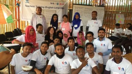 Group of people at a classroom setting in a camp. 