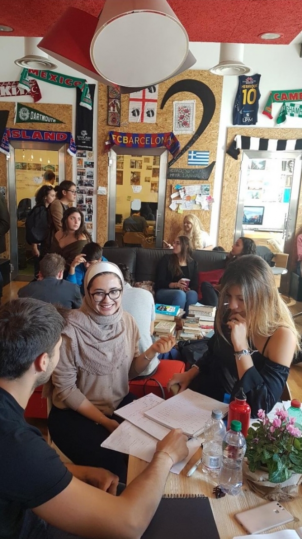 A group of students studying together at a cafe.