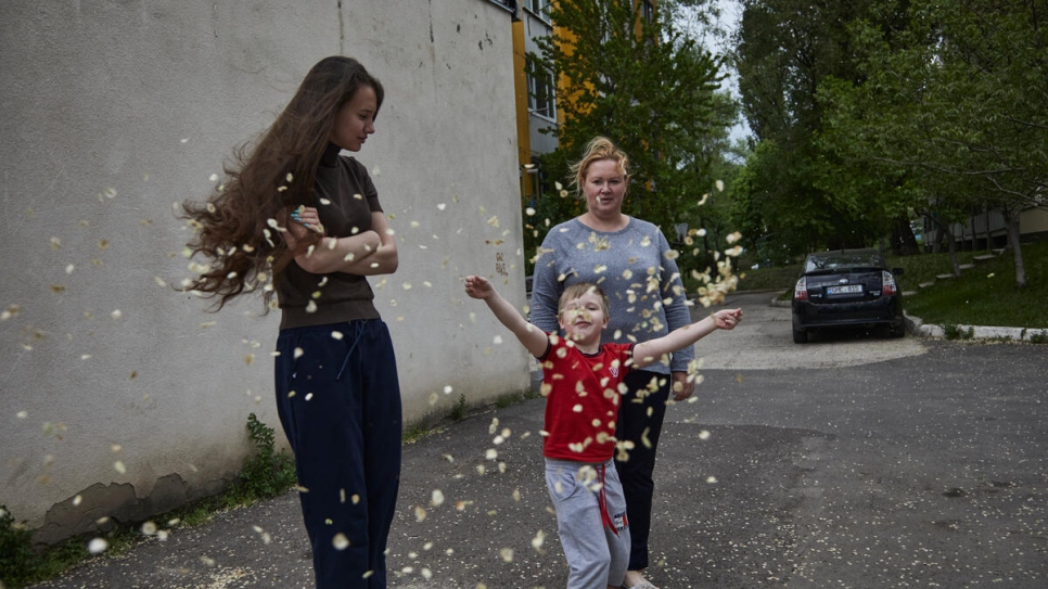 The family pictured outside their accommodation in Chisinau where they have lived for the last month. 