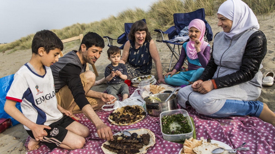 "Community sponsorship is very rewarding. It's a little kernel of perfection, but it's too small in Britain. This is too good to waste, it should spread."

Vicky Moller (centre) has a picnic at a beach in south Wales with the Alchik family, Muhaned, his wife Naheda, and their children (from left) Shadi, 8, Hadi, 1, and Sara, 9. Vicky initiated the Croeso Teifi community group that brought the family to Cardigan. The process started almost three years ago by gathering people, formalising a committee, forming a charity and navigating the application process, including visits to the area by the UK Home Office.