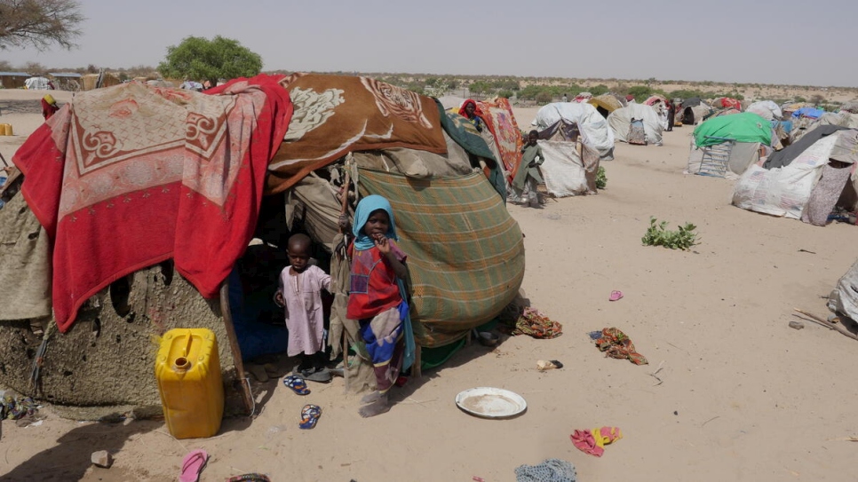 Chad. Two kids standing in a hut in Forkolom internal displaced persons' camp, near Lake Chad