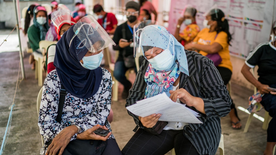 Sama Bajau community members go through the process of birth registration at Zamboanga City's civil registry office. 