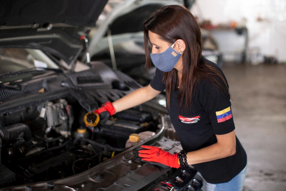 Displaced Venezuelan Samira works as a mechanic in the car repair workshop she runs in Salta, Argentina.