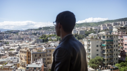 A boy looks out over a city