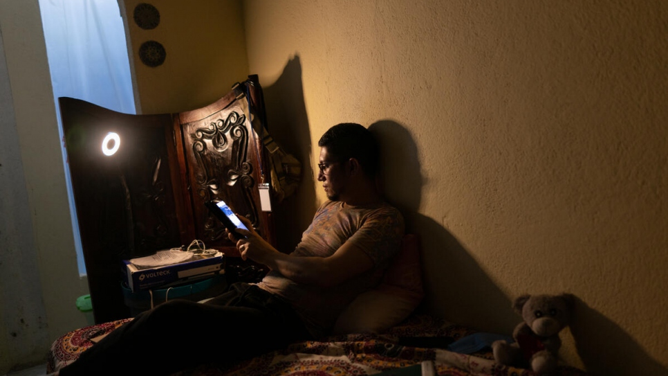 Nicaraguan asylum-seeker Óscar* reads from a tablet that he uses for professional development classes.