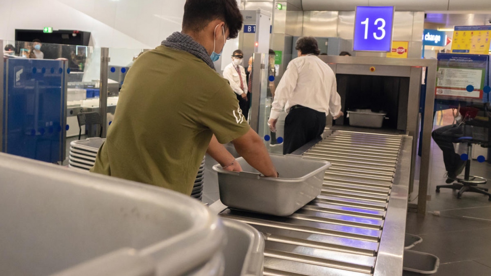 A group of unaccompanied children go through security to board a flight from Athens to Lisbon, under an EU relocation scheme.