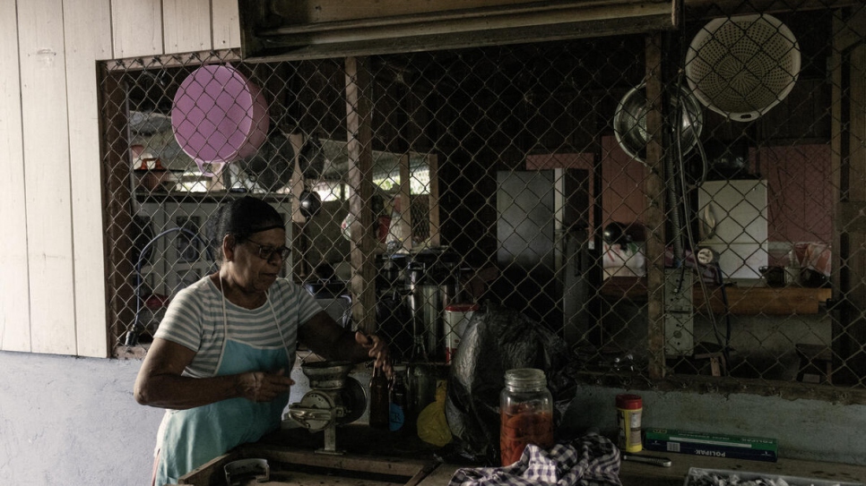 Vicenta, hard at work in the kitchen of her farmhouse, checks on a batch of handmade chocolates.