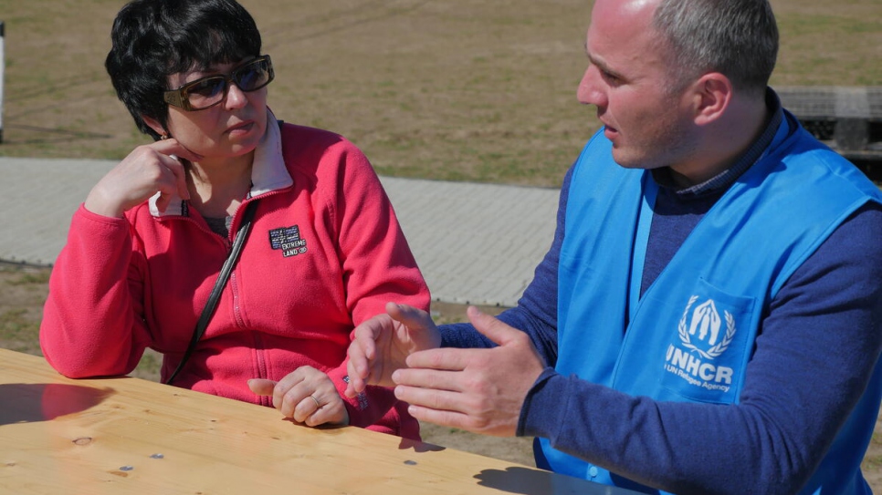 Ukraininan refugee Natasha Titova receives advice from a UNHCR staff member at a reception centre in Michalovce, Slovakia.