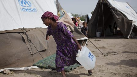 Pakistan / Floods / A young girl collects water at a camp for displaced persons near the city of Sukker in Sindh, Pakistan. Across Pakistan, some 17 million people have been affected, with 8m people in need of emergency relief. Almost a month since the start of the flooding, the humanitarian crisis is still growing. Aid agencies say the amount of aid available is a long way from meeting the needs of those affected. A lack of proper sanitation and cramped living conditions mean disease could spread quickly though the temprorary camps that have been set up along the route of the Indus. / UNHCR / J. Tanner / 28 August 2010 ;