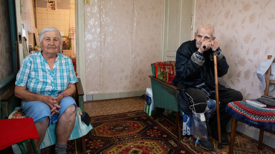 Viktor and his wife, Antonina Akimov, 84, in their home in Stanytsia Luhanska. Viktor has serious health issues and struggles to walk. 
