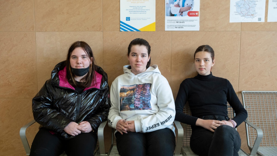 Angelina, 18 (centre), with her sister Albina, 14 (left), and cousin Victoria, 18, in a waiting room at Rzeszow train station. Angelina accepted a lift from a stranger when she arrived in Poland from Ukraine.