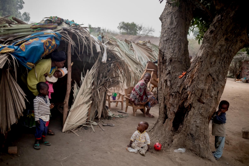 Pascaline and her children emerge from their shelter after a night's sleep.