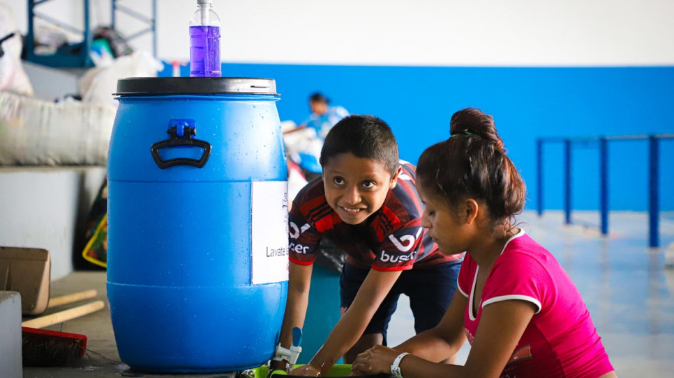 Indigenous Warao refugees from Venezuela wash their hands, having been relocated to a safe shelter in Manaus, northern Brazil.