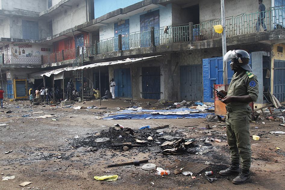 A security officer stands in the Madina market in Conakry, Guinea, following clashes between rival political party supporters on October 9, 2015.