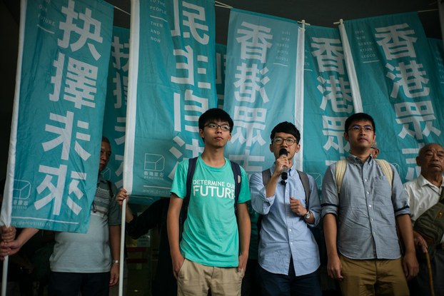 Leaders of Hong Kong's 'Umbrella Revolution' Joshua Wong (C), Nathan Law (center R), and Alex Chow (2nd R), following their sentencing for their roles in 2014 protests in Hong Kong, Aug. 15, 2016.
