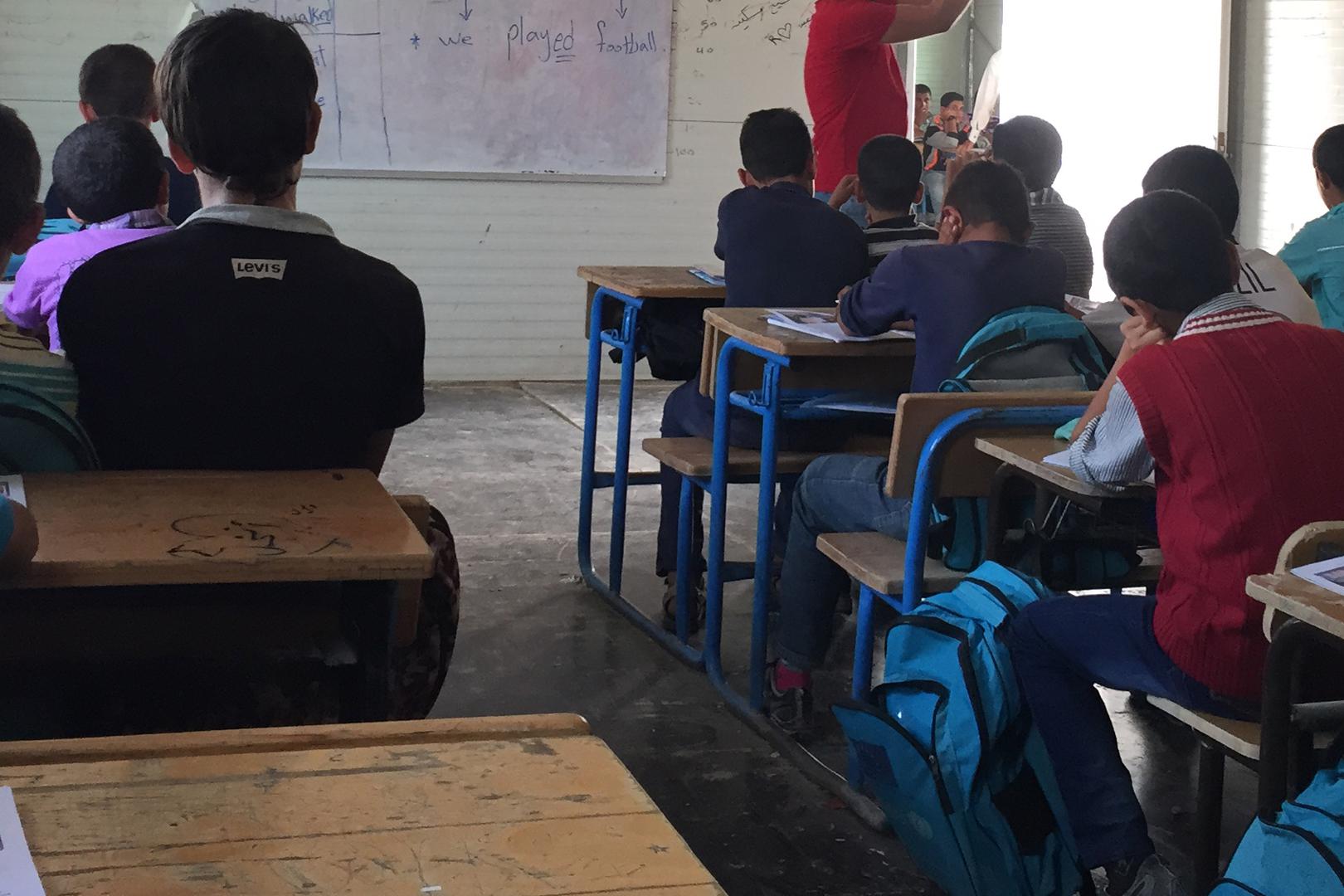 Syrian children attend class in a school in the Zaatari refugee camp in northern Jordan, October 20, 2015. The school taught Syrian girls in the morning and boys in the afternoon, but lacked electricity, heating, and running water.