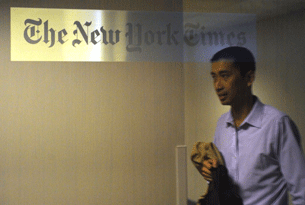 A man walks past the New York Times office in Shanghai, Oct. 30, 2012.