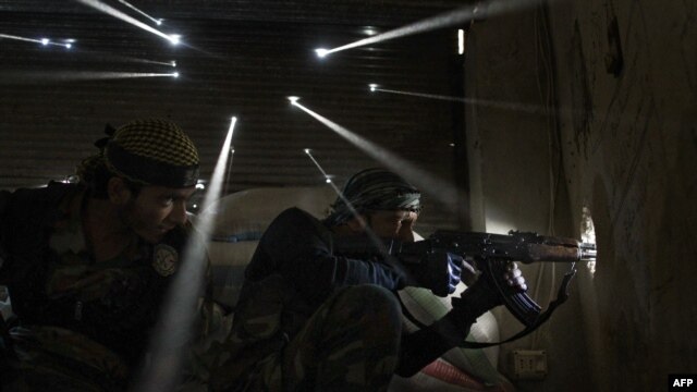 Two rebels take sniper positions during fighting in Aleppo, Syria. (file photo)