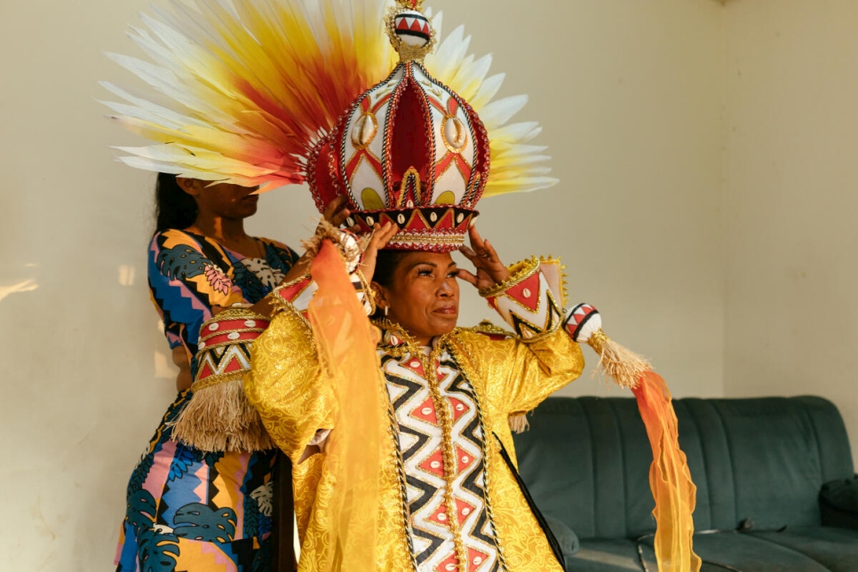 A los pocos meses de su llegada a Río, la refugiada venezolana Ingrid Bucán se alista para su debut en el desfile, ayudada por su hija.