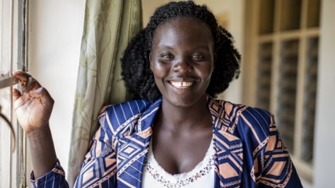 UNHCR, the UN Refugee Agency - Esther smiles into the camera. She is a third-year student in commerce at Makerere University in Kampala. 