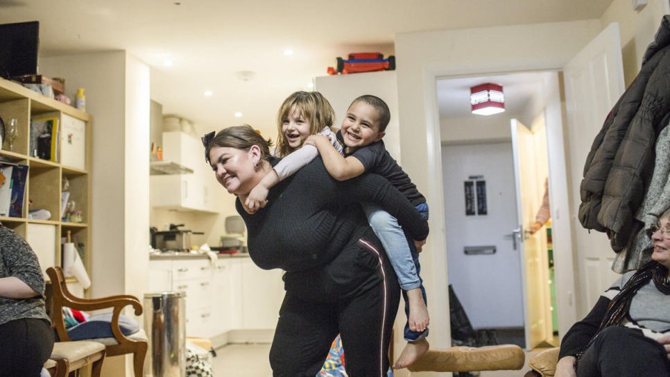 Amy Chapman plays with Adbul, 4, and Noor, 6, at the Arnout family home in Ottery St Mary, Devon, south-west England. Amy is a friend of the family and often drops by to help the children read English