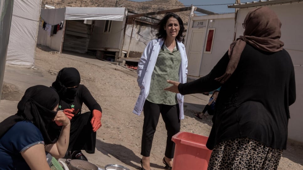 Dr. Nagham Hasan speaks with residents of Rwanga camp, which is home to some 2,442 Yazidi families and 104 survivors of ISIS enslavement.