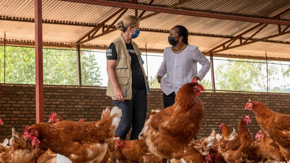 Kelly Clements, UNHCR's Deputy High Commissioner and Clementine Nkweta-Salami, the Regional Director for Africa's East, Horn, and Great Lakes Region stand in one of the poultry houses run by refugees and Rwandans in Rwanda. 