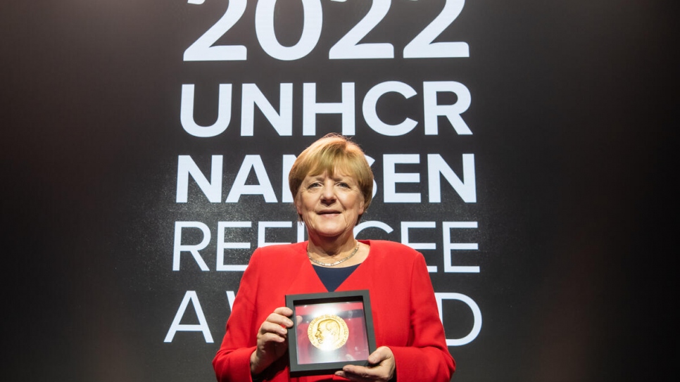 Dr. Merkel poses with the Global Laureate award during the 2022 UNHCR Nansen Refugee Award ceremony.