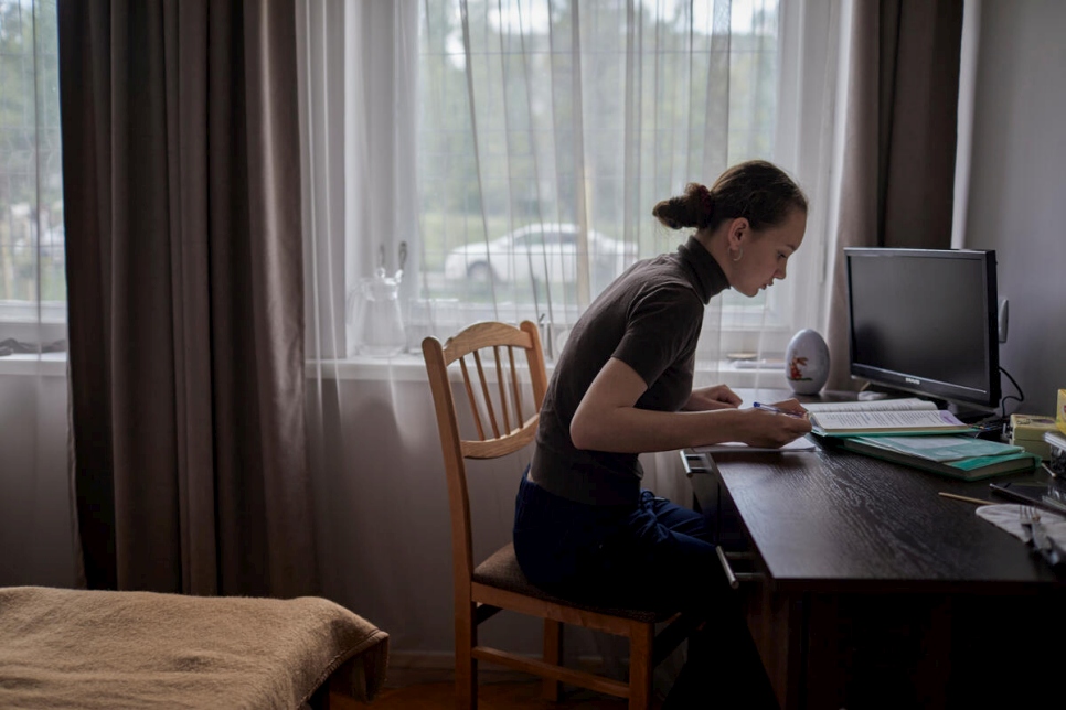 Daria studies at a desk in the family's bedroom where she joins online classes with her teachers and classmates from Ukraine.