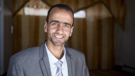 UNHCR, the UN Refugee Agency - Monther Alhoshan smiles happily into the camera, wearing a suit and a tie. One week ago he graduated in law from nearby Al-Albayt University,