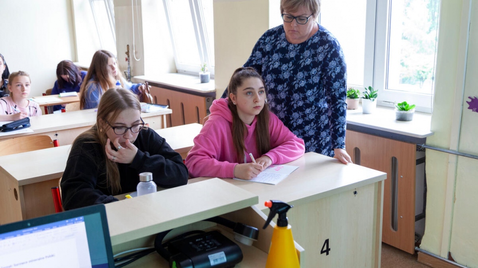 Teacher Ewa Golofit leads a geography class for Sofia and her fellow students.