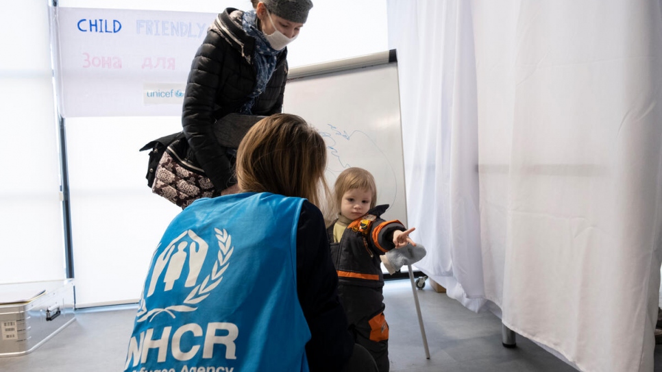 The cash enrolment centre includes a child-friendly space for young children like Andre, and their mothers.