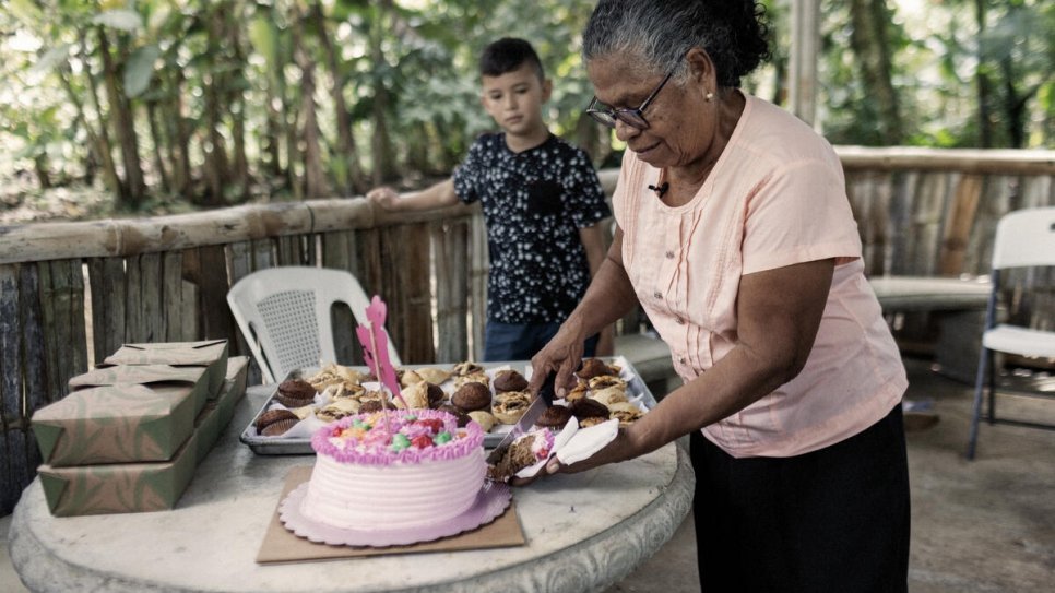 Vicenta serves a cake for Mother's Day, an important public holiday in Costa Rica, to her family and other guests gathered at her farm for the occasion.
