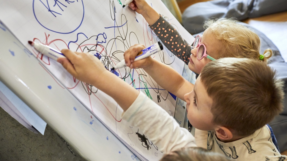 Young Ukrainian refugees draw together at Zi de Bine, which means "Day of Good". 