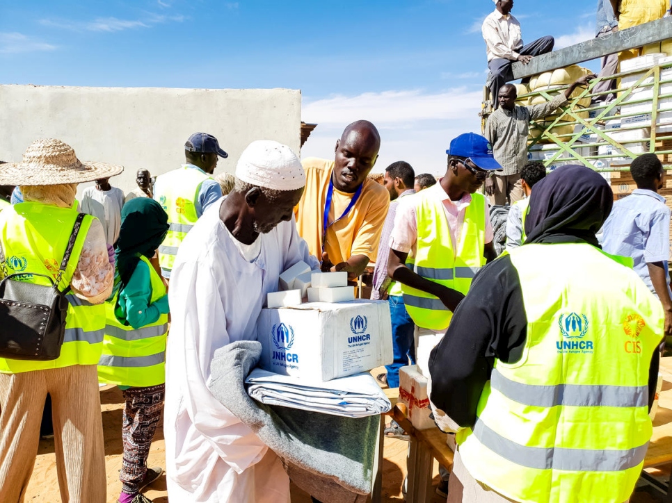 UNHCR, the UN Refugee Agency - Santino Cual Chan receiving UNHCR plastic sheeting, a blanket, a kitchen set and soap.