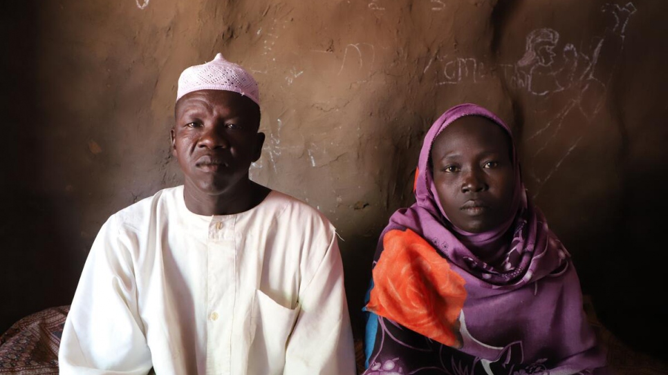 Bereaved parents Abrahim Ahmed Adahir (left) and Hawa Farouk sit in their one-room home at Doro refugee camp, Maban County, South Sudan.