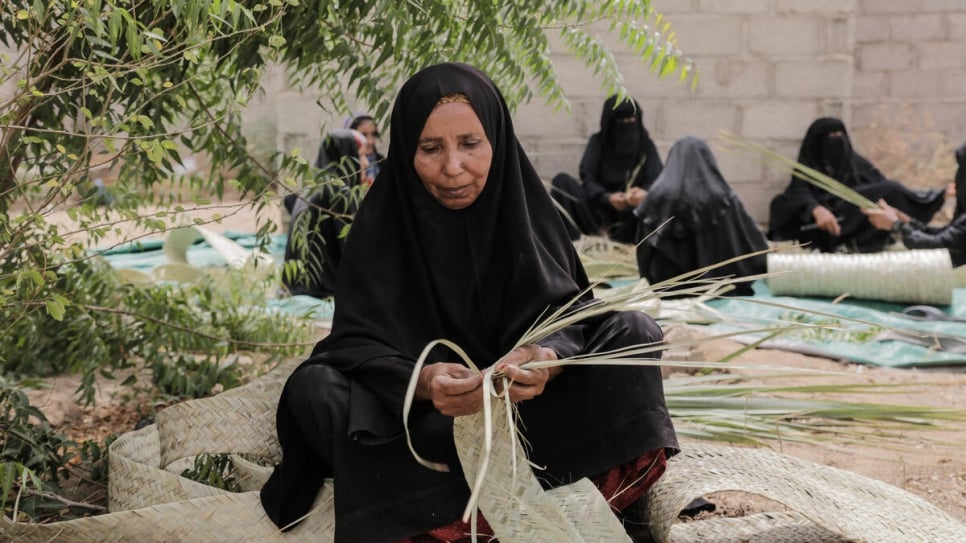 Des femmes yéménites sur un site de déplacement près de Hodeïda tissent des feuilles de palmier khazaf utilisées pour la construction d'abris durables. 