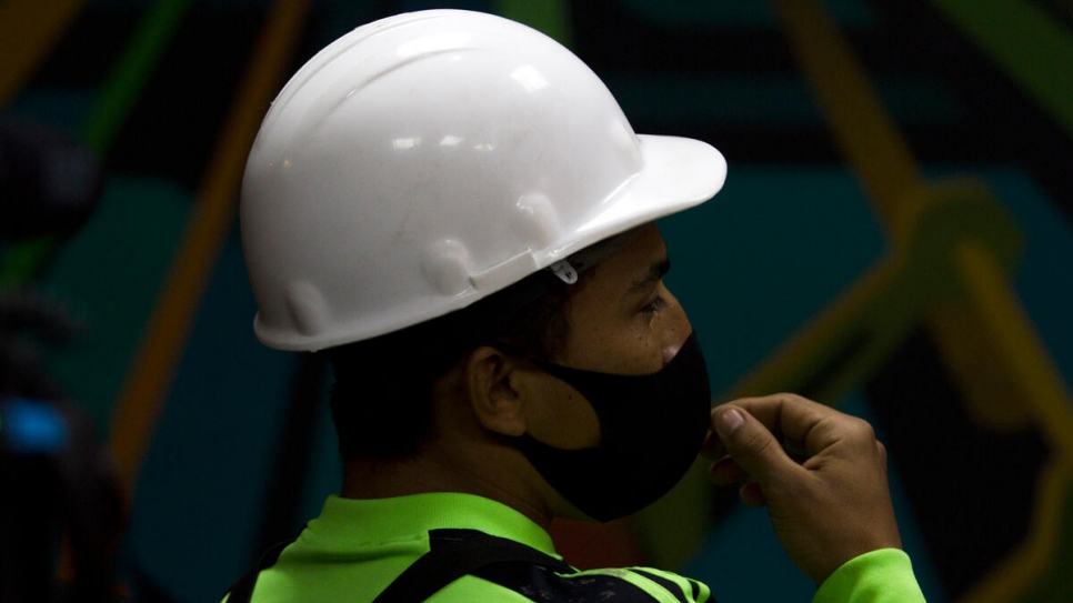 Salvadoran refugee Jorge Gonzalez takes a break during his shift at paper mill GreenPaper in Monterrey, Mexico.