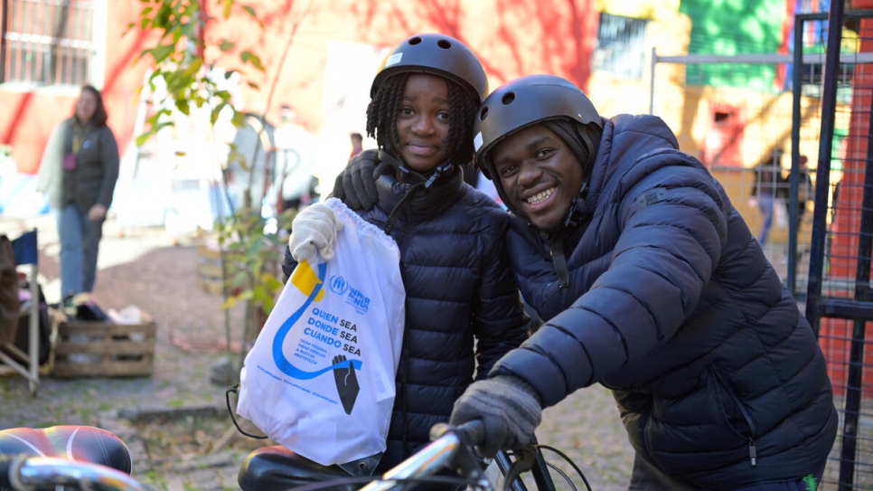 Two youngsters who moved to Argentina with their parents from the Democratic Republic of the Congo take part in the bike ride in Buenos Aires.