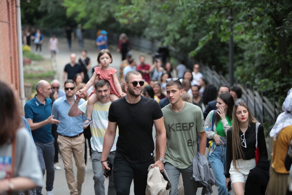 People take part in a Solidarity Walk in Tbilisi Botanical Gardens, Georgia, in support of forcibly displaced people around the world.