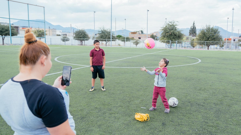 As part of her children's online physical education class, Dania records the kids at play.