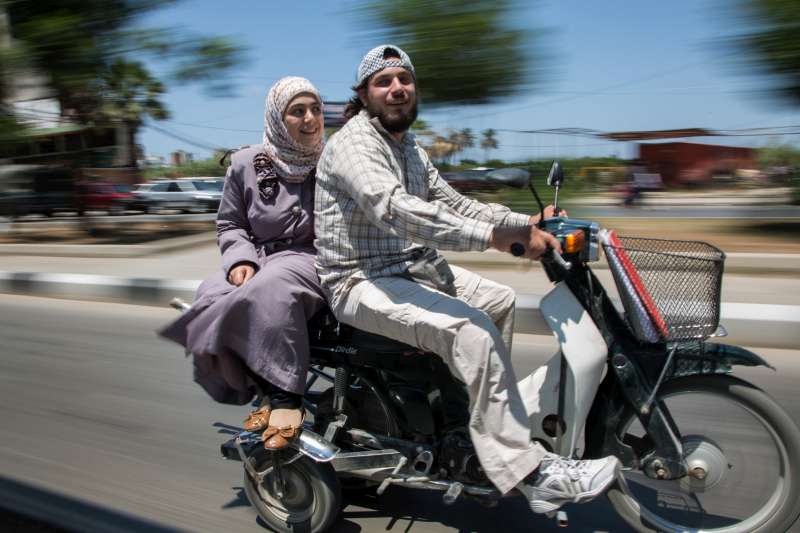 Ahmad  and his wife, Nazmiya , leave a UNHCR volunteer meeting at the UNHCR offices in Tripoli, Lebanon. 