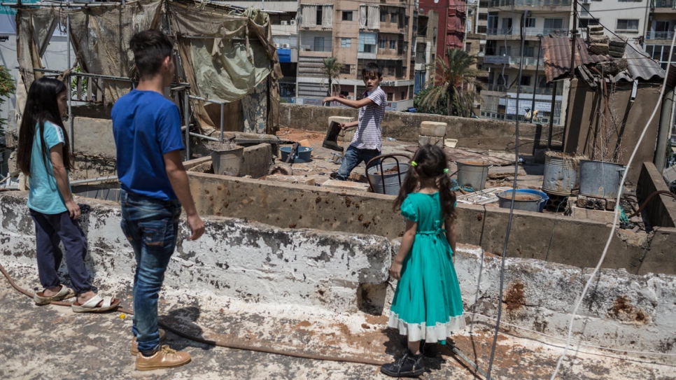 Zain (second from right) plays with his brother Hussein and sisters, Iman (left) and Riman (right), on the rooftop of their Beirut apartment.