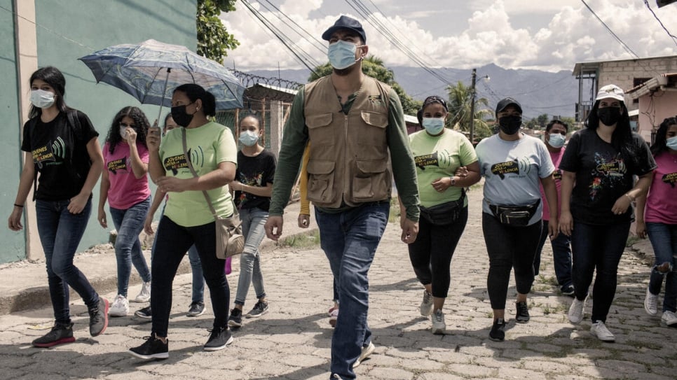 Santiago and volunteers from Jóvenes Contra la Violencia walk through a neighbourhood in Comayagua City where gangs are active to check on families.