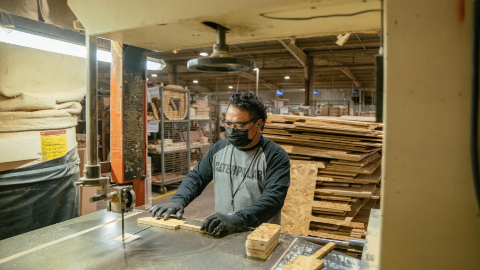 Cesar has found work at a furniture plant, slicing the wood that will become sofas and chairs.