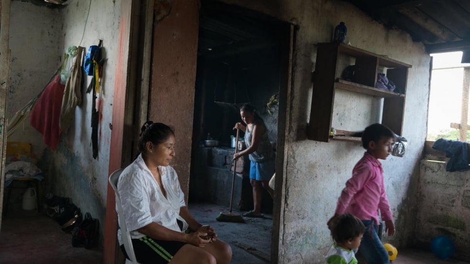 Luz Mari Bisbicus Pai, 41, takes a break after having cooked for her family. Being married to the community leader, Luz was lucky enough to have a working kitchen. The other 16 families living in shacks have to make-do by cooking outside on open fires.