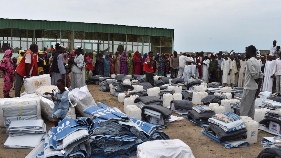 Sudanese communities affected by recent flooding receive relief items like plastic sheets, blankets, kitchen sets and jerrycans.
