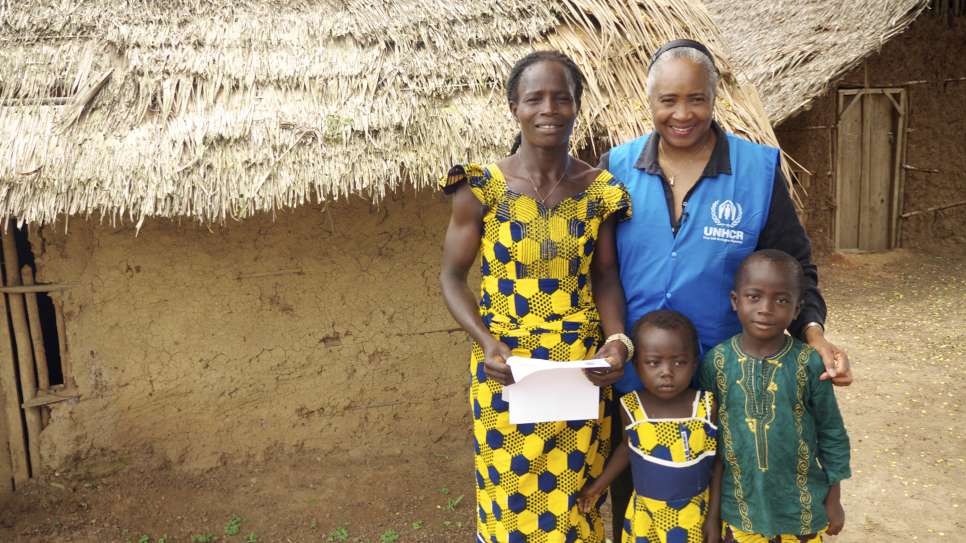 Barbara Hendricks stands with Elise in the village of Dronguine, Cote D'Ivoire. Elise's children had just been given their birth certificates preventing them from being Stateless. July 2014